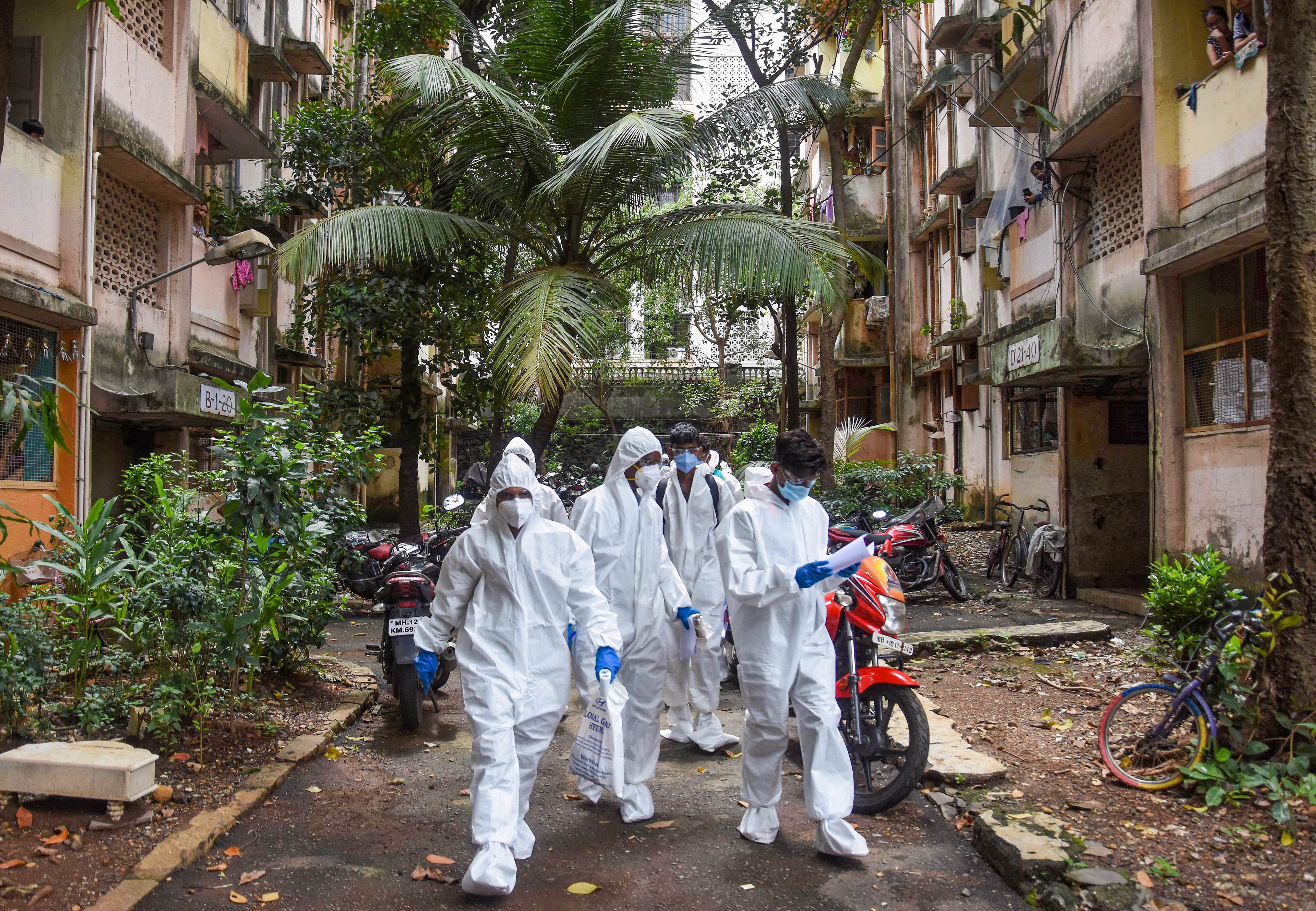 Health workers arrive to conduct door-to-door screening of residents of Dindoshi in the wake of coronavirus pandemic, at Goregaon East in Mumbai. Credit: PTI