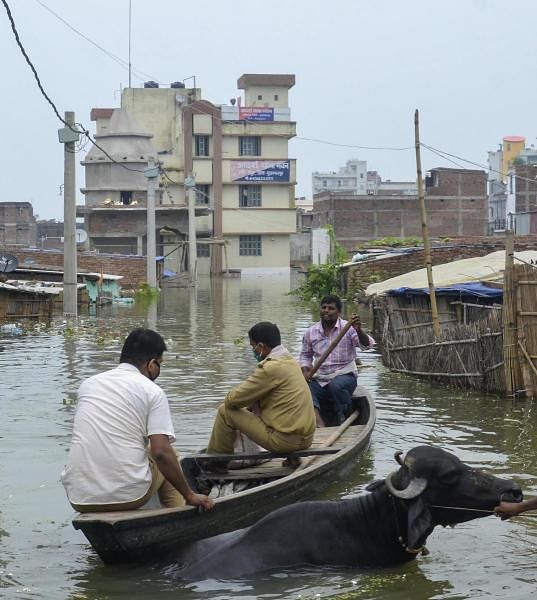 Police personnel use a boat to move across a flooded area, in Muzaffarpur. Credit: PTI Photo