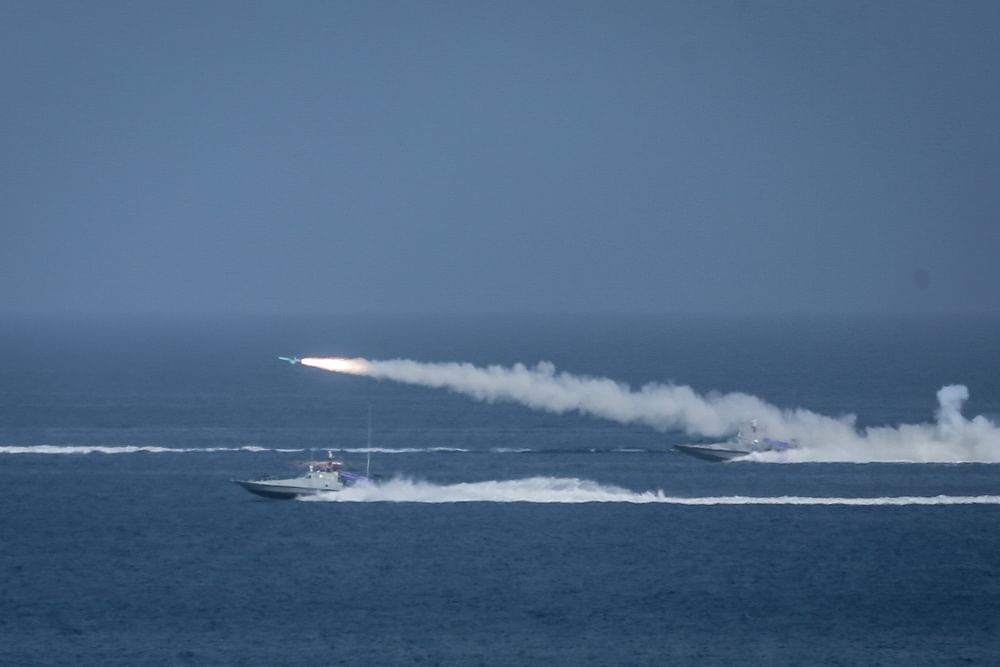 This handout photo provided by Iran's Revolutionary Guard Corps shows a missile being fired from a boat during a military exercise near the Strait of Hormuz. Credit: AFP Photo