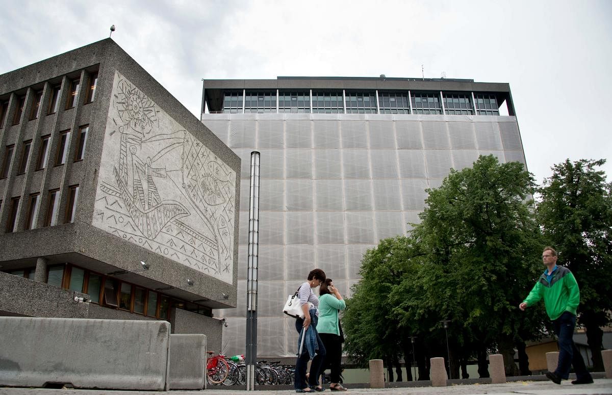 People pass Picasso's mural art work "The Fisherman" (L) on the government quarter's 'Y building' in Oslo, Norway on August 6, 2013. Credit: AFP File Photo