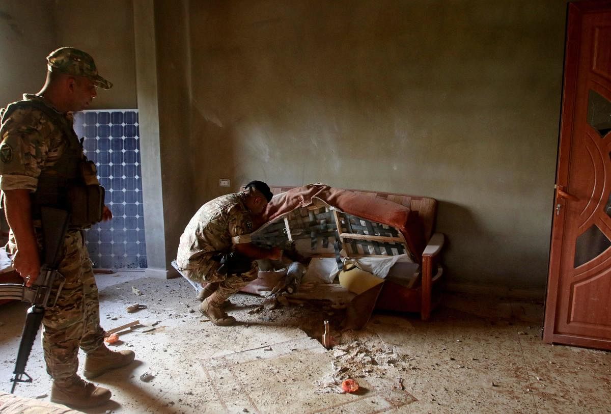 A bomb expert from the Lebanese army inspects an unexploded ordnance inside a home in Hebarieh village, after reported Israeli bombardment of the Shebaa Farms sector following reports of clashes in the Lebanese-Israeli border area. Credit: AFP