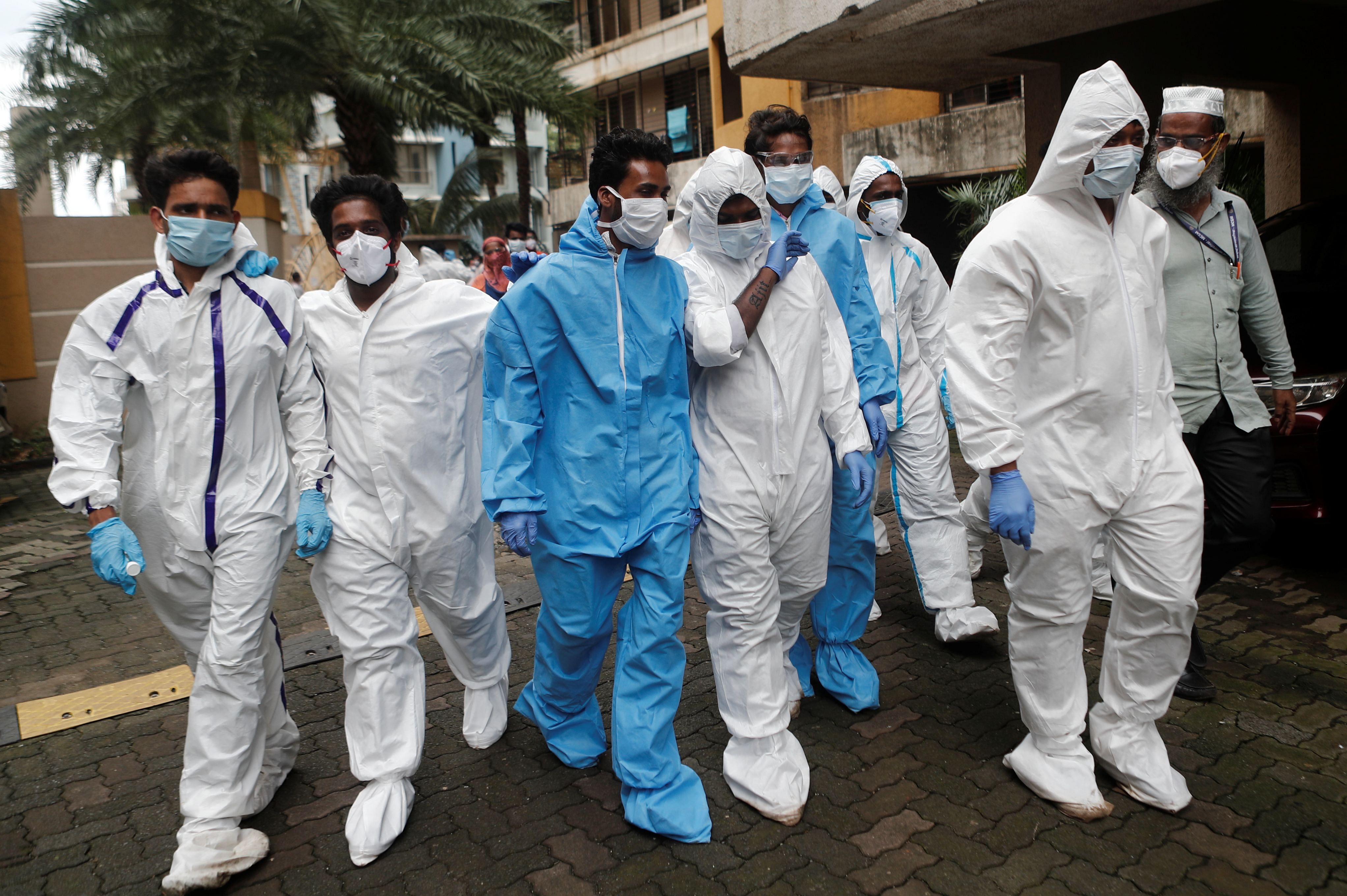 Health workers in personal protective equipment (PPE) enter a residential building complex during a check up campaign for the coronavirus disease (COVID-19) in Mumbai. Credit: Reuters