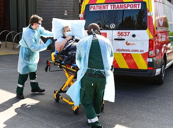Ambulance officers transport a resident from the Epping Gardens aged care facility in the Melbourne. Credit: AFP
