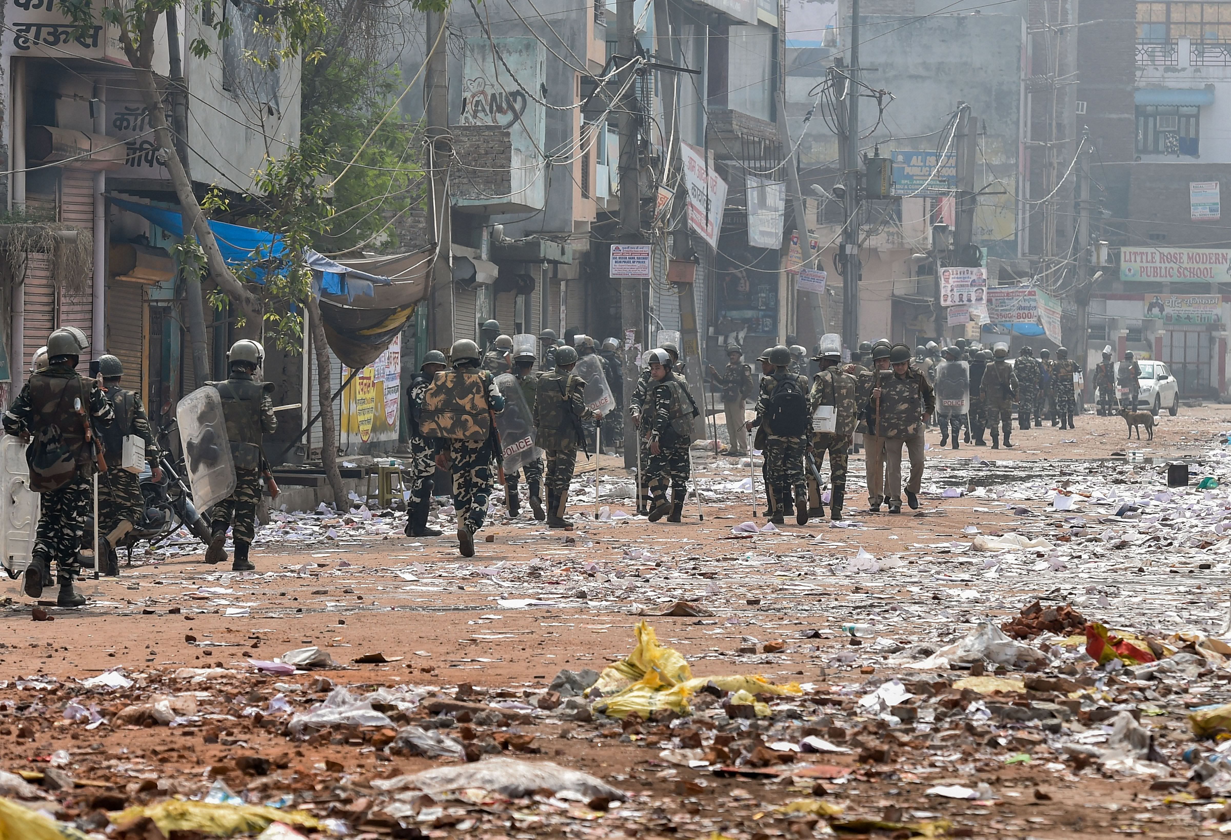 Security personnel conduct patrolling as they walk past Bhagirathi Vihar area of the riot-affected north east Delhi, Wednesday, Feb. 26, 2020. At least 22 people have lost their lives in the communal violence over the amended citizenship law as police struggled to check the rioters who ran amok on streets, burning and looting shops, pelting stones and thrashing people. Credit: PTI Photo