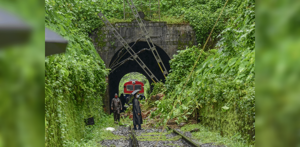 Kottayam: Railway officials inspect a track, damaged due to a landslide following heavy rain, at Muttamplam in Kottayam district. Credit: PTI Photo