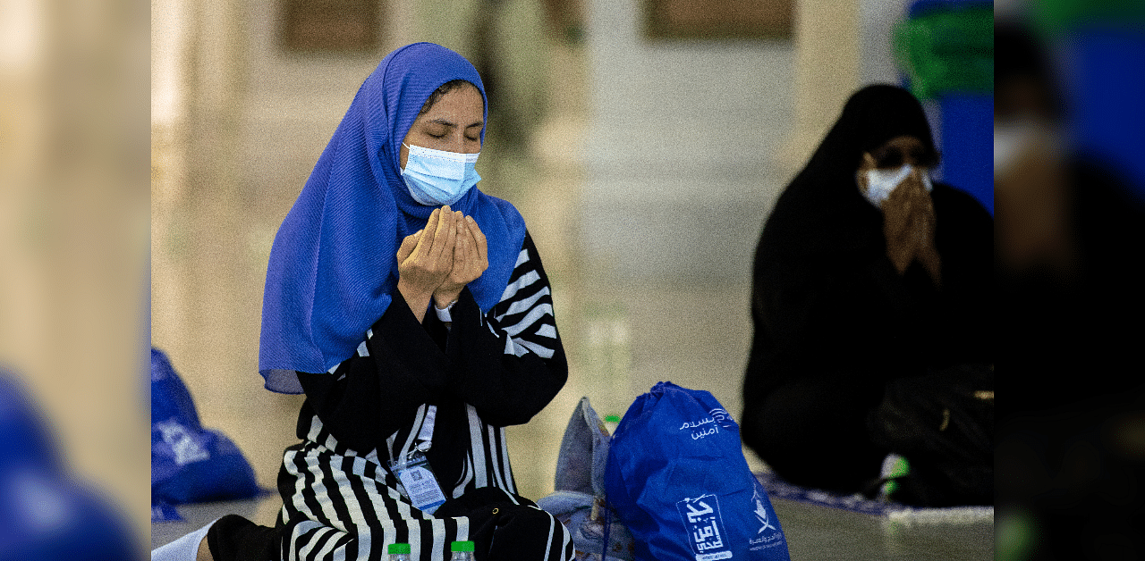 Muslim pilgrims wearing protective face masks pray around the Kaaba at the Grand mosque during the annual Haj pilgrimage amid the coronavirus. Credits: Reuters Photo