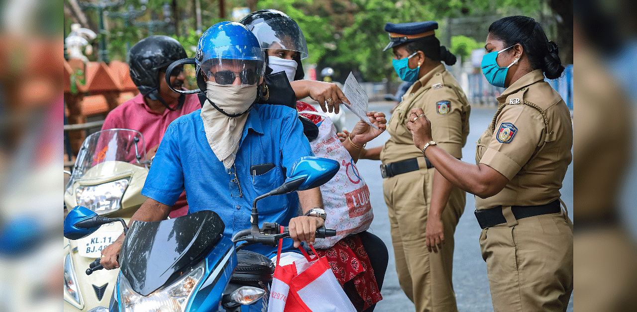 Police personnel question commuters who defied curfew during a 21-day nationwide lockdown, in the wake of coronavirus. Credits: PTI Photo