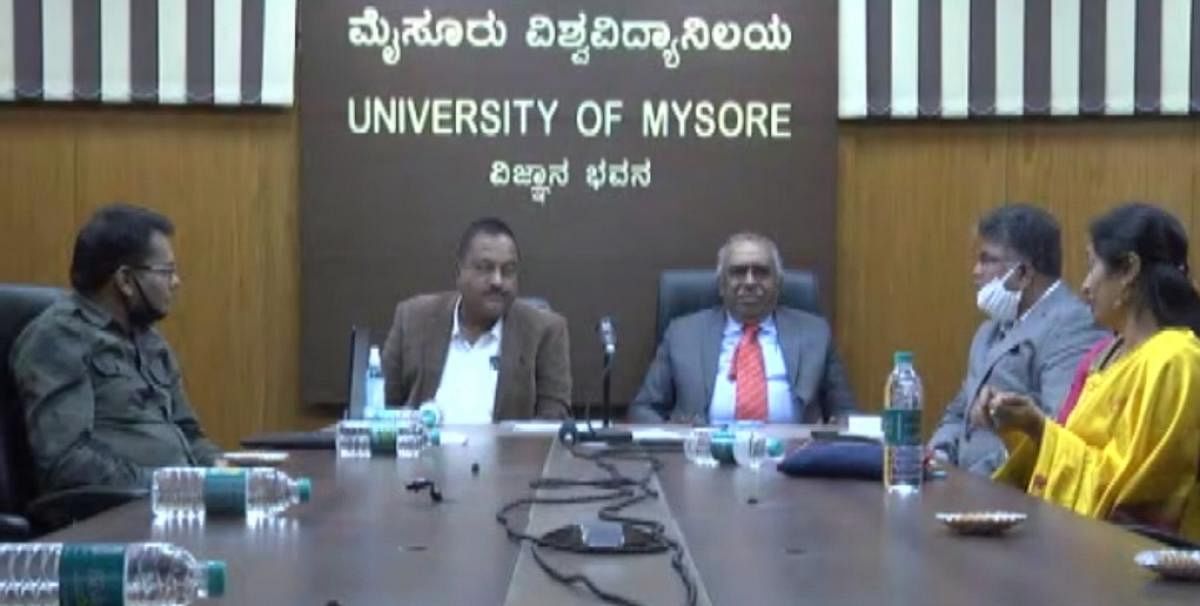 Bandipur Tiger Reserve Director T Balachandra delivers a talk on Tigers on the occasion of International Tiger Day at University of Mysore in Mysuru on Wednesday. MM Hills Wildlife Deputy Conservator of Forests V Yedukondalu, UoM VC G Hemantha Kumar, Regi