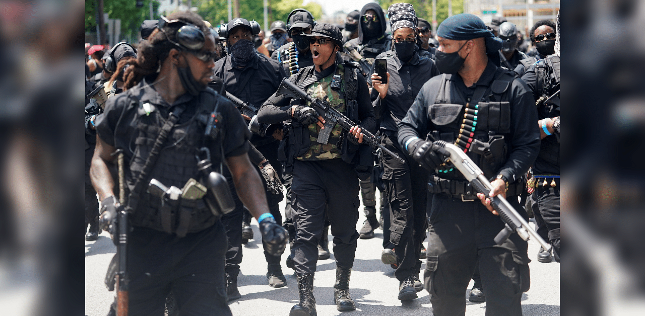 Members and supporters of an all-Black militia group called NFAC hold an armed rally in Louisville. Credits: Reuters Photo