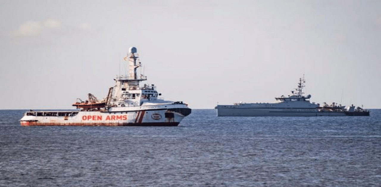 The Italian Guardia di Finanza boat sails towards the Spanish migrant rescue NGO ship Open Arms to retrieve 27 unaccompanied minors and take them to the Italian island of Lampedusa. Credit: AFP Photo