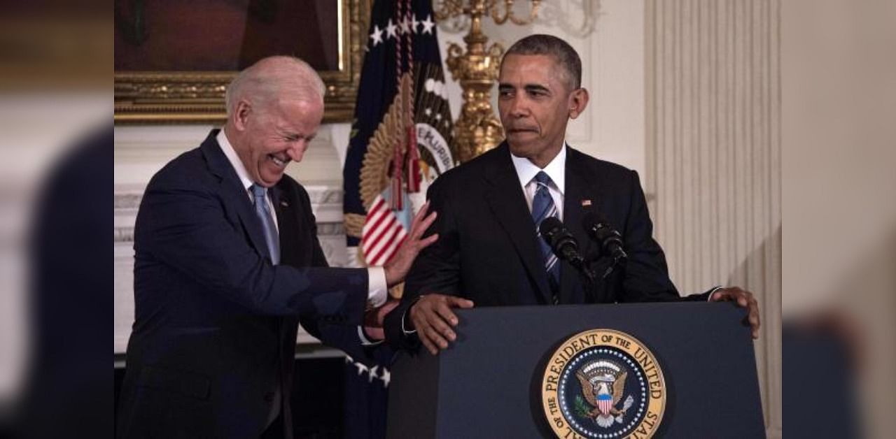 US Vice President and Presidential candidate Joe Biden laughs as President Barack Obama speaks during a tribute to Biden at the White House in Washington, DC. Credit: AFP Photo