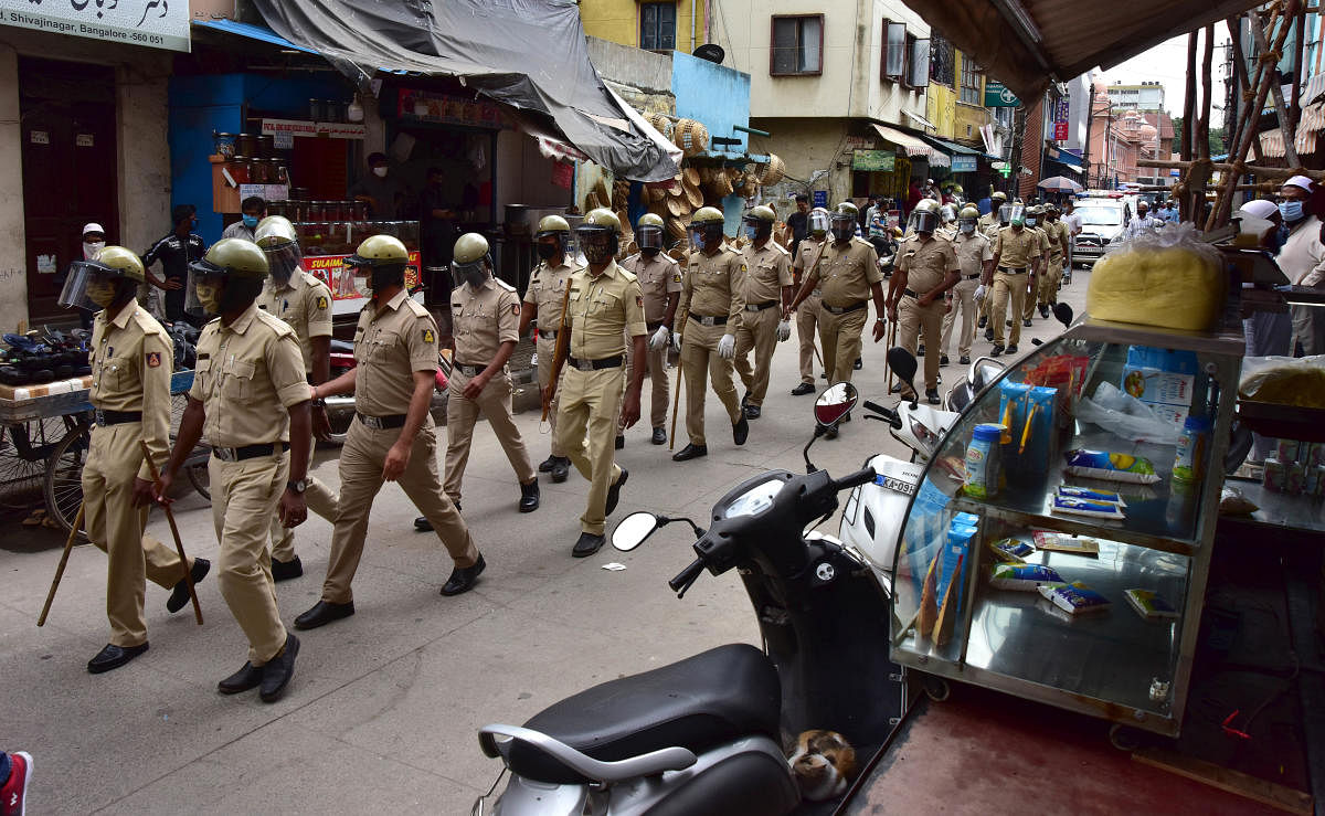 Police personnel conduct a route march in Shivajinagar. DH Photo/Irshad Mahammad