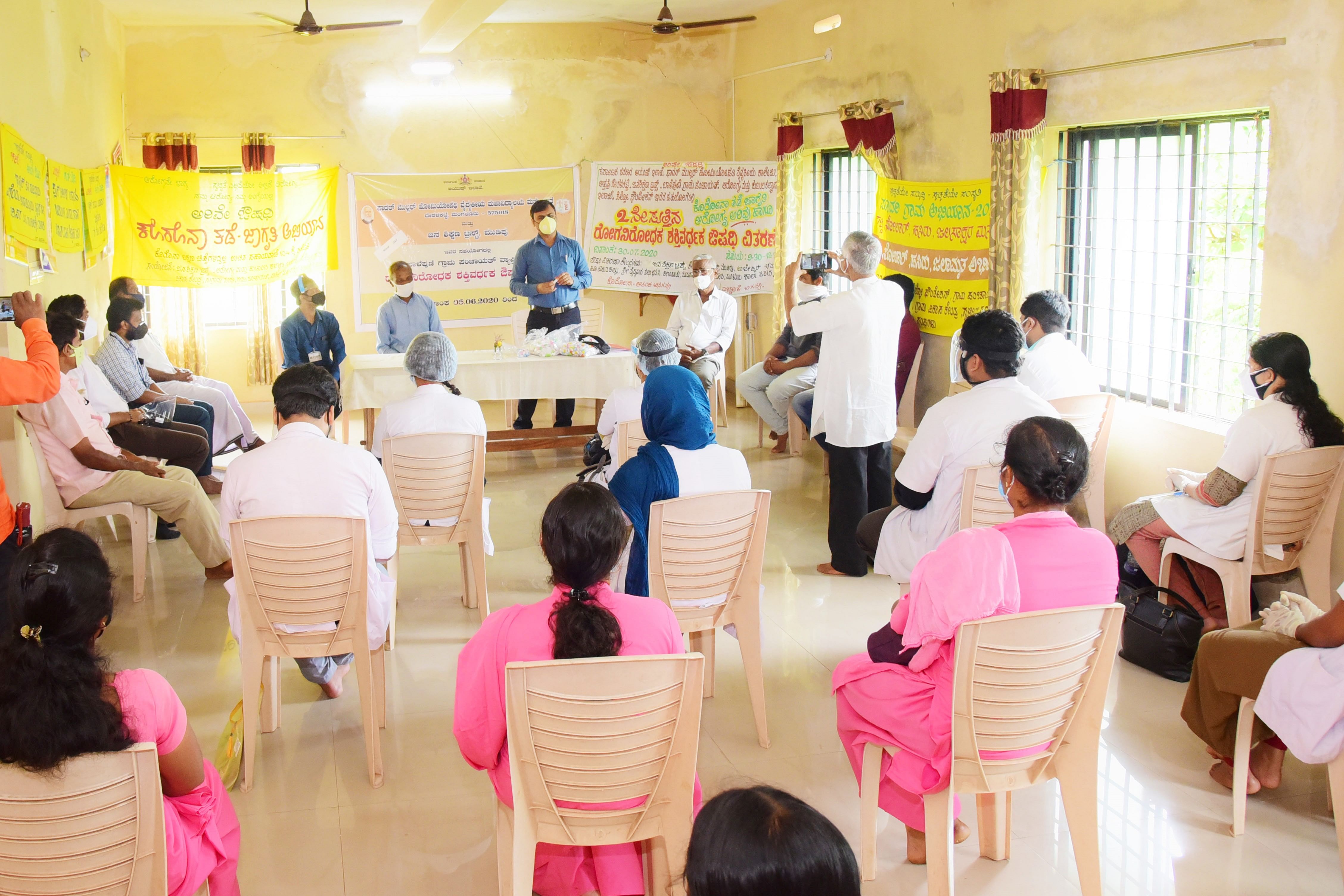 DK ZP CEO Dr Selvamani speaks at a programme organised to create awareness on Covid-19 and to distribute immunity boosting medicines at Balepuni gram panchayat in Bantwal. The programme was jointly organised by Fr Muller Homoeopathic Medical College, Ayush department, Jana Shikshana Trust, Selco Foundation, Department of Health and Family Welfare