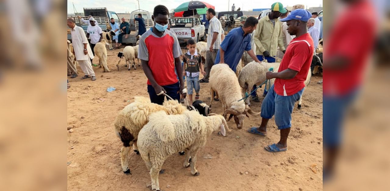 People visit a livestock market ahead of the Eid al-Adha celebrations, amid the coronavirus disease pandemic, in Misrata, Libya. Credit: Reuters