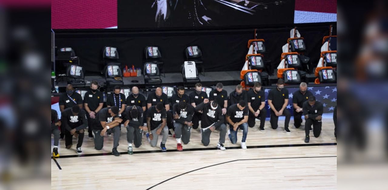 Players kneel during the national anthem before the start of an NBA basketball game between the New Orleans Pelicans and the Utah Jazz. Credit: USA Today Sports