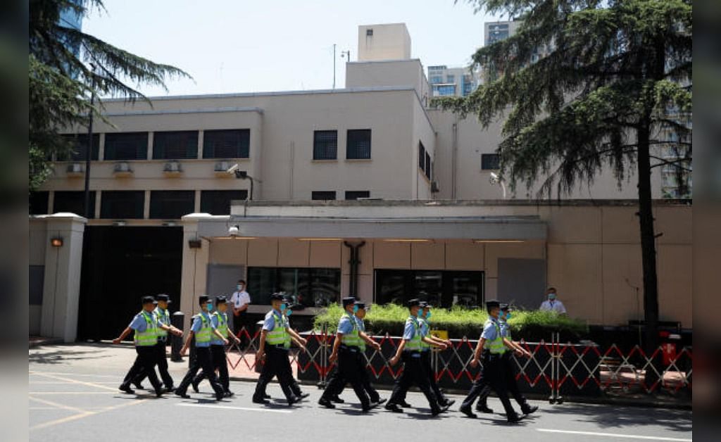 Police march in front of the former U.S. Consulate General in Chengdu. Credit: Reuters