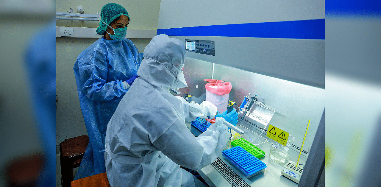 Medics at the real-time Polymerase Chain Reaction laboratory (PCR lab) at the Kalamassery Medical College Hospital. Credit: PTI Photo