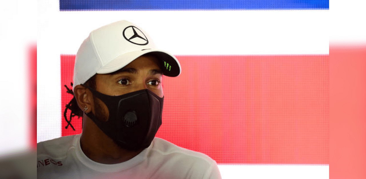 Mercedes' Lewis Hamilton wears a face mask during a press conference. Credit: Reuters Photo