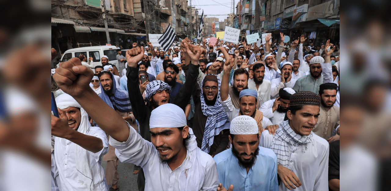 People chant slogans in a protest rally in favor of a man, who according to the police, is suspected of killing US national Tahir Ahmed Naseem during a proceeding at a judicial complex, in Peshawar, Pakistan. Credit: Reuters Photo
