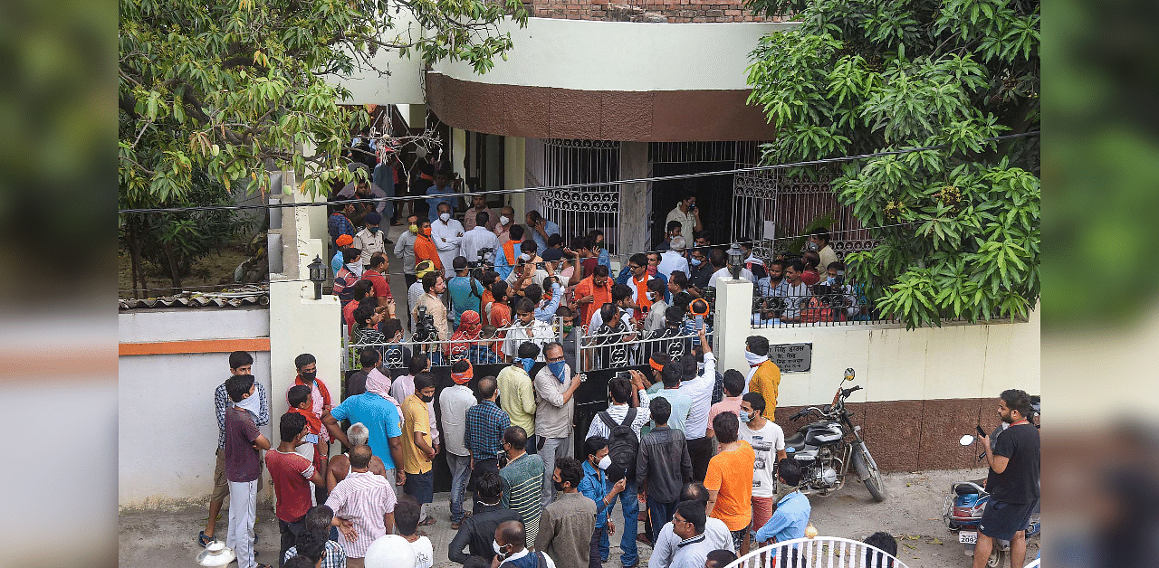 Kins and fans of Bollywood actor Sushant Singh Rajput gather outside his residence. Credits: PTI Photo