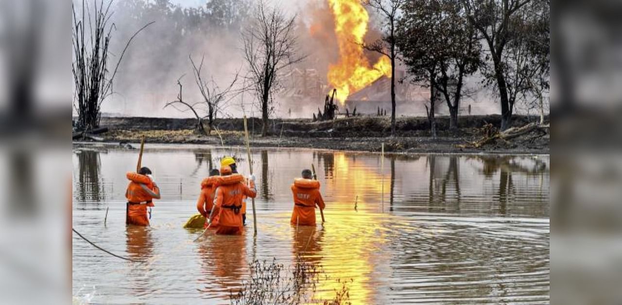 National Disaster Response Team (NDRF) personnel carry out search and rescue operations after two firemen of Oil India Limited went missing since an oil well at the company’s Baghjan oilfield exploded, in Assam’s Tinsukia district, Wednesday, June 10, 2020. Credit: PTI Photo