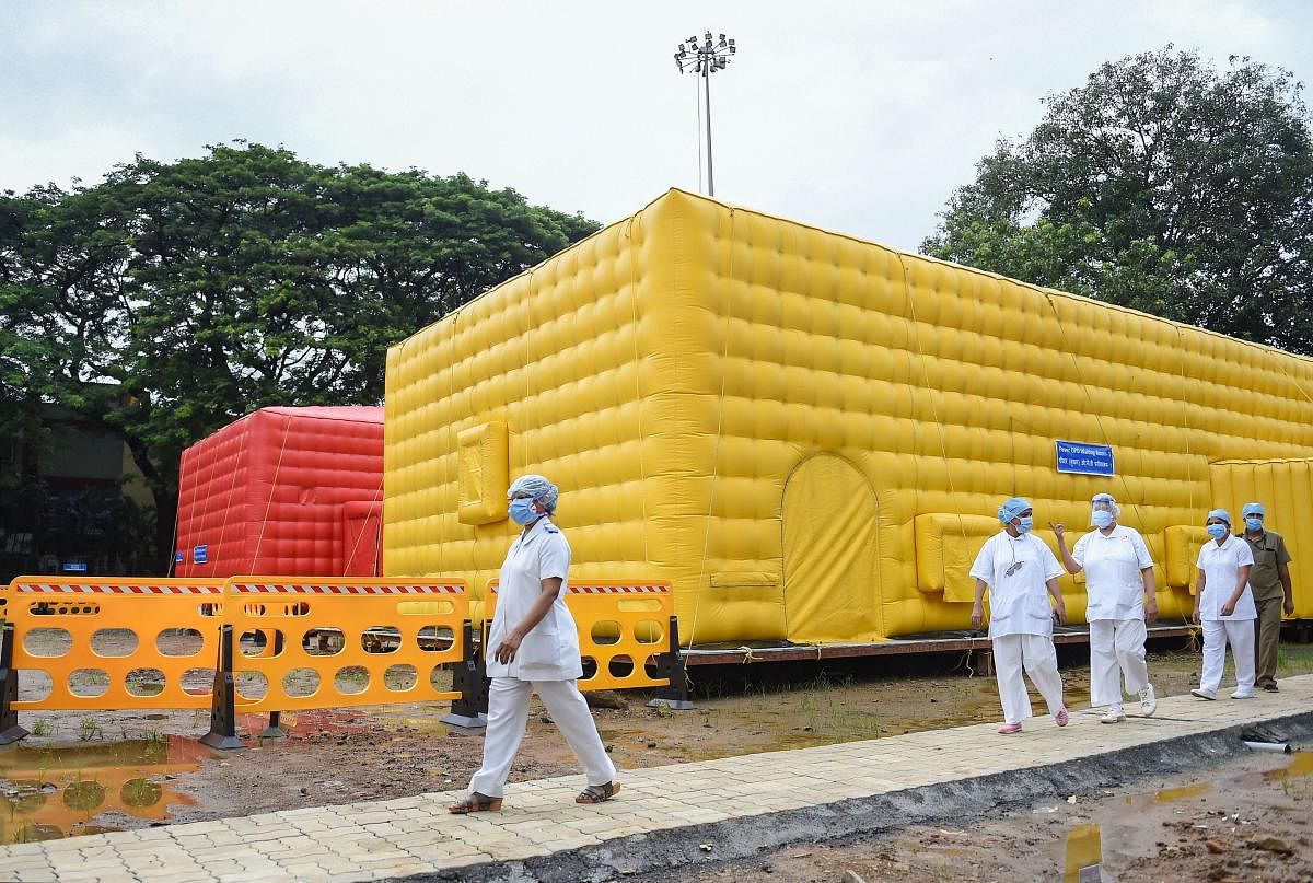 Nurses from the Tata Memorial Hospital walk past a temporary facility created to facilitate cancer patients diagnosed with Covid-19, in Mumbai, Thursday, July 30, 2020. PTI