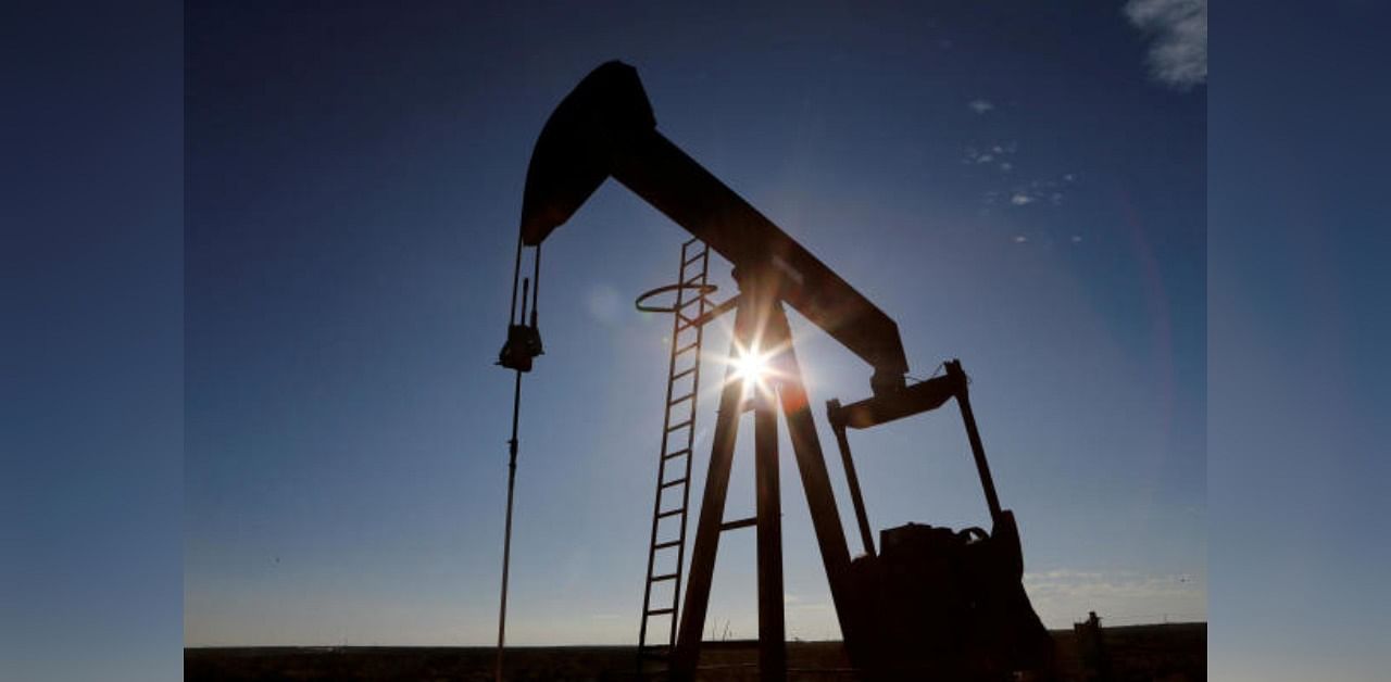 The sun is seen behind a crude oil pump jack in the Permian Basin in Loving County, Texas, US. Credit: Reuters Photo