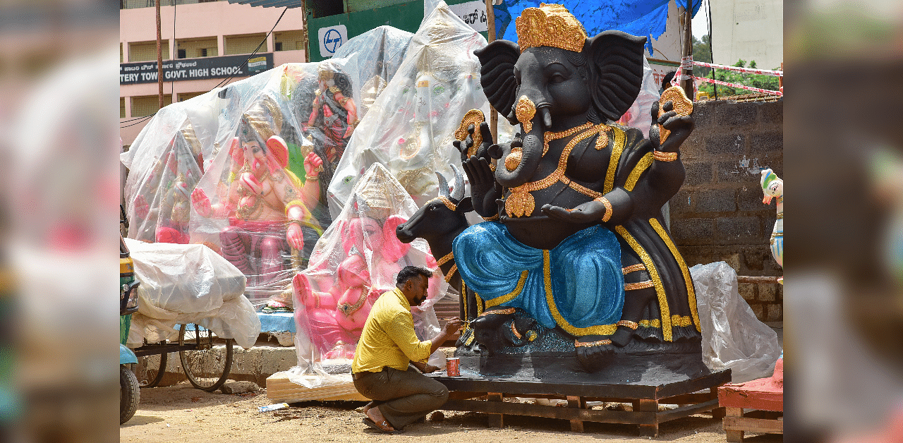 An artist seen giving final touch to lord Ganesha idol, at Pottery Town in Bengaluru. Credit: DH File Photo