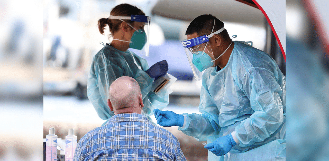 A medical personnel holds a swab while administering a test for the coronavirus disease (COVID-19) at a pop-up testing centre, as the state of New South Wales grapples with an outbreak of new cases, in Sydney, Australia. Credit: Reuters