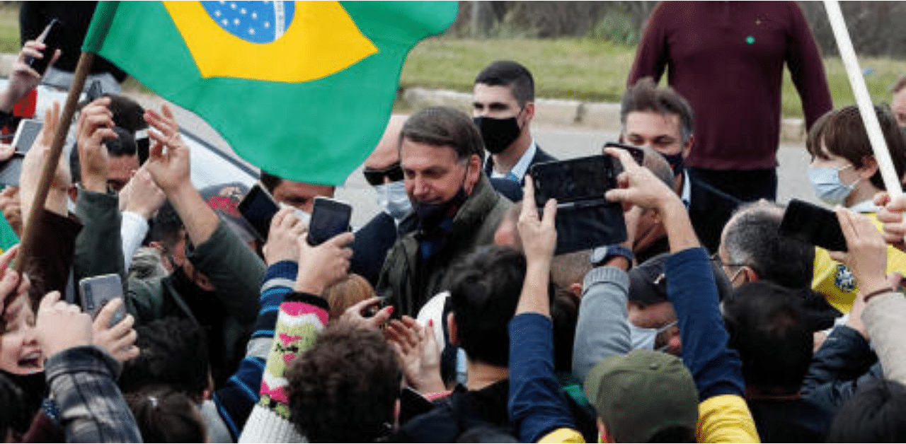 Brazil's President Jair Bolsonaro is greeted by supporters, amid the coronavirus disease outbreak. Credit: Reuters Photo