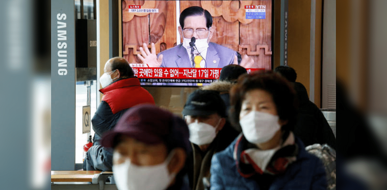 People watch a TV broadcasting a news report on a news conference held by Lee Man-hee, founder of the Shincheonji Church of Jesus the Temple of the Tabernacle of the Testimony, in Seoul, South Korea. Credit: Reuters Photo