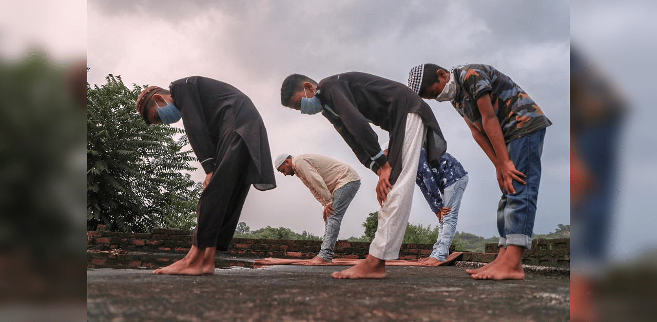 A Muslim family offers namaz at their residence on the occasion of Eid al-Adha during the complete weekend lockdown imposed to curb the spread of coronavirus. Credit: PTI