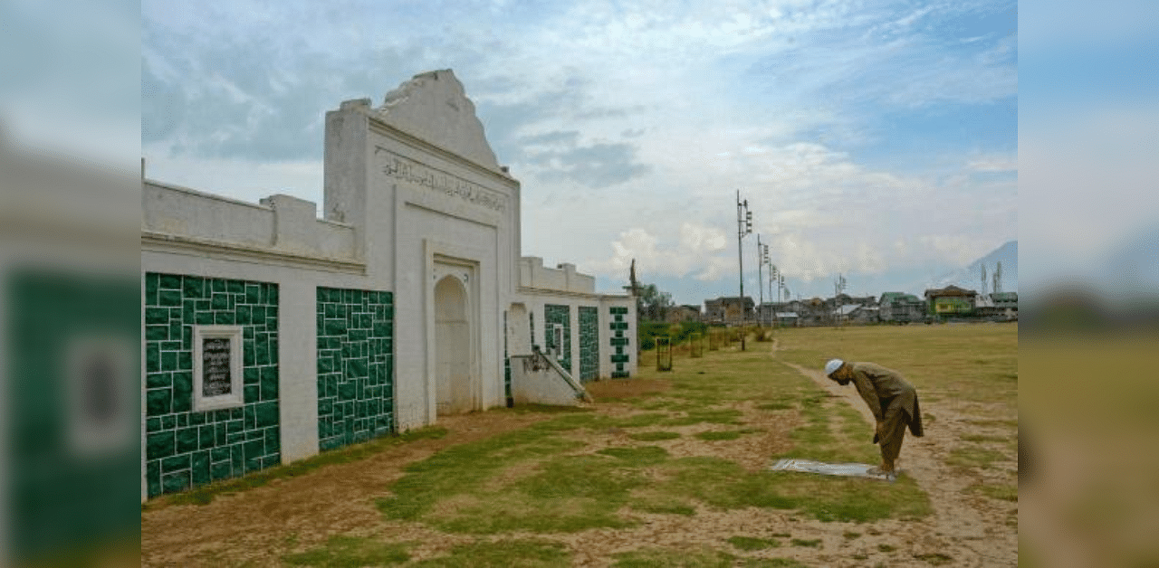 A member of the Muslim community offers namaz at Eidgah ground on the occasion of Eid al-Adha, during the complete lockdown, in Srinagar. Credit: PTI Photo