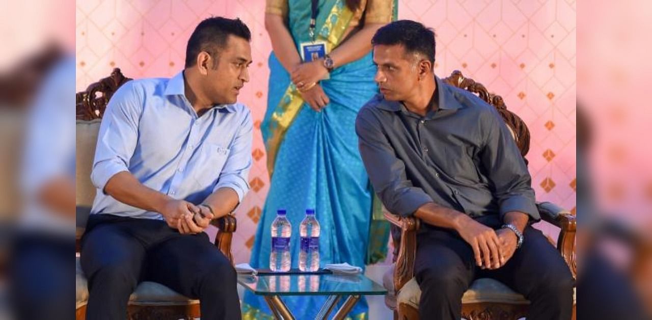 Indian cricketer MS Dhoni speaks with former Indian cricketer Rahul Dravid during the launch of a book, in Chennai, in 2018. Credit: PTI