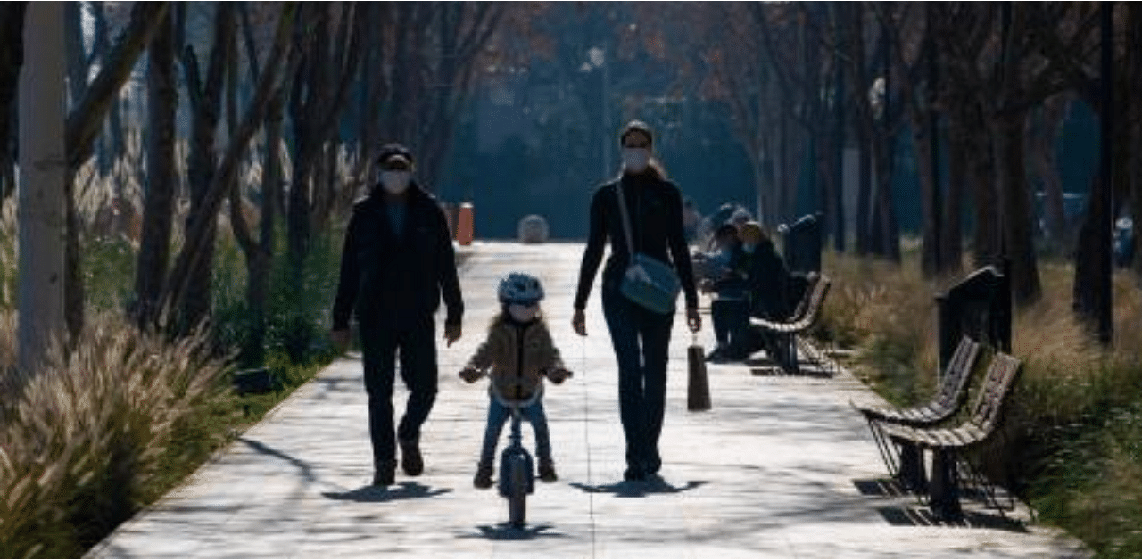 A family enjoys the sunshine at a park of Santiago's Vitacura commune, on July 28, 2020, after lockdown measures to fight the novel coronavirus pandemic were relaxed. Credit: AFP