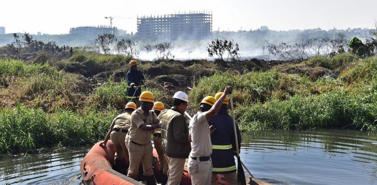 Firefighters inspecting the Bellandur lake in Bengaluru on Saturday. Bellandur Lake, known for its high levels of pollution, caught fire. Credit: PTI/file