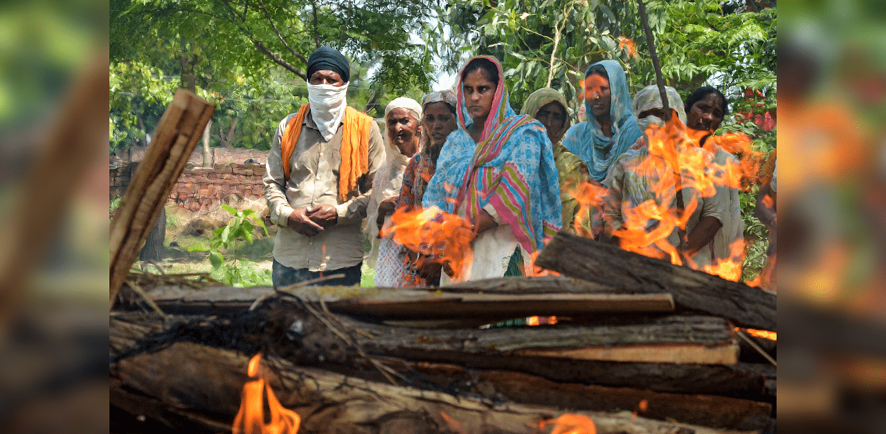 Family members and relatives attend the cremation of Kirpal Singh, who died after allegedly consuming spurious liquor, at Mucchal village near Amritsar. Credits: PTI Photo