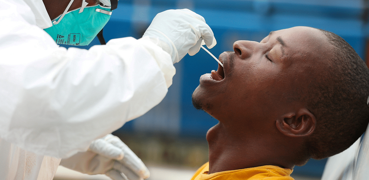  A member of medical staff swabs the mouth of a resident as she is testing him for a virus, during a nationwide lockdown for 21 days to try to contain the coronavirus disease. Credits: Reuters Photo