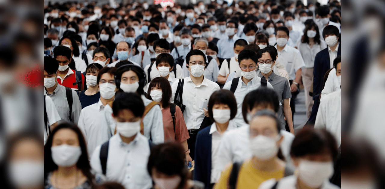  People wearing protective masks amid the coronavirus disease outbreak, make their way during rush hour at a railway station in Tokyo. Credit: Reuters File Photo