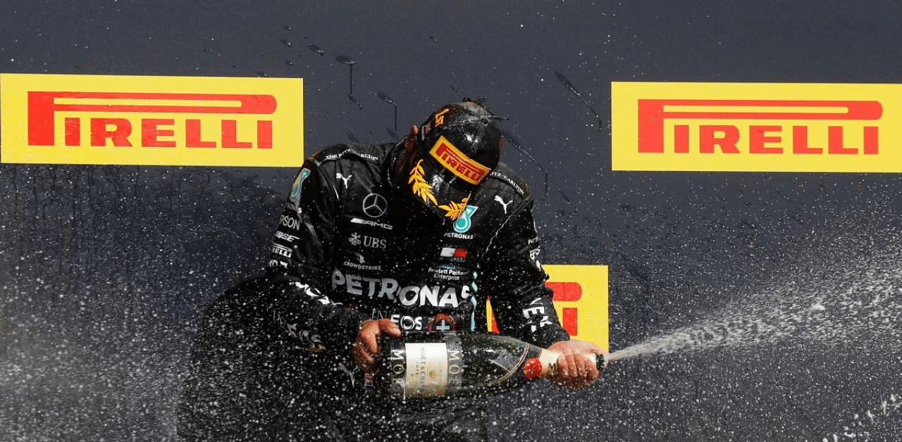  Mercedes' Lewis Hamilton celebrates winning the race on the podium. Credit: Reuters Photo