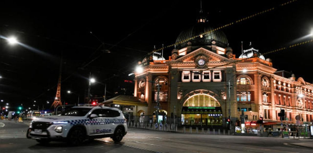A police car is seen outside Flinders Street Station after a citywide curfew was introduced to slow the spread of the coronavirus disease. Credit: Reuters
