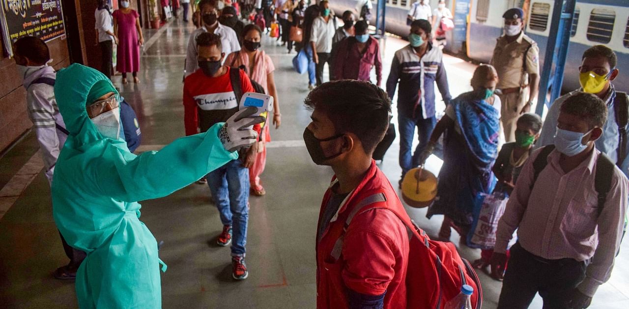 Migrant labours undergo thermal screening at Dadar railway station, in wake of the coronavirus pandemic, in Mumbai. Credit: PTI Photo