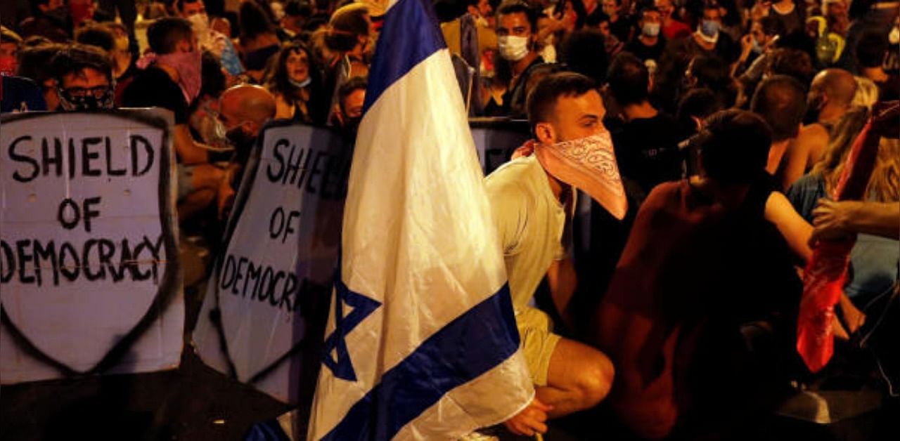 People take part in a demonstration against Israeli Prime Minister Benjamin Netanyahu's alleged corruption and his government's way of handling of the coronavirus disease. Credit: Reuters