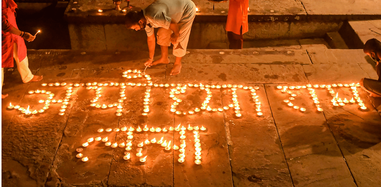 Devotees light earthern lamps during Ganga 'aarti' at Dashashmedh Ghat, ahead of the foundation laying ceremony of Ram Temple in Ayodhya, in Varanasi, Sunday, Aug. 2, 2020. Credit: PTI Photo