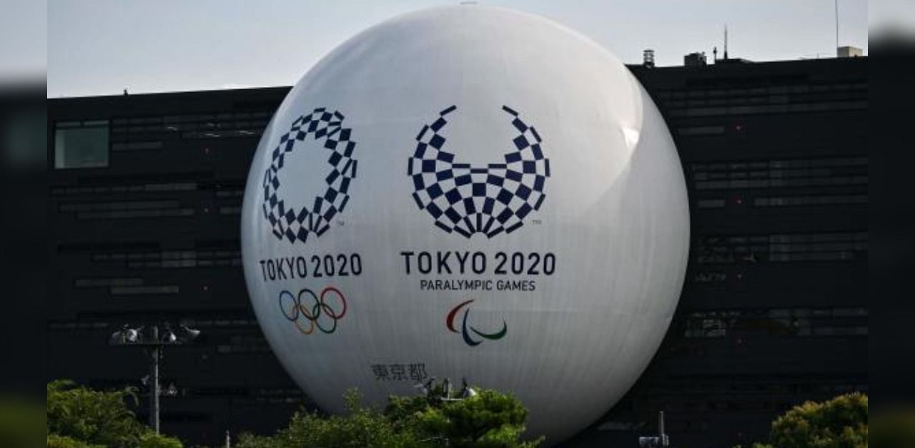 Tokyo 2020 Olympic and Paralympic logos are displayed on the Hinomaru driving school building in Tokyo. Credit: AFP