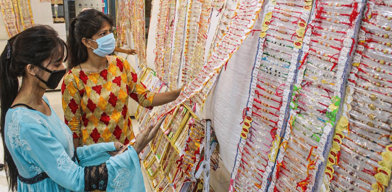 Women purchase 'rakhi' ahead of Raksha Bandhan festival at Sadar Bazaar, in Gurugram. Credit: PTI Photo