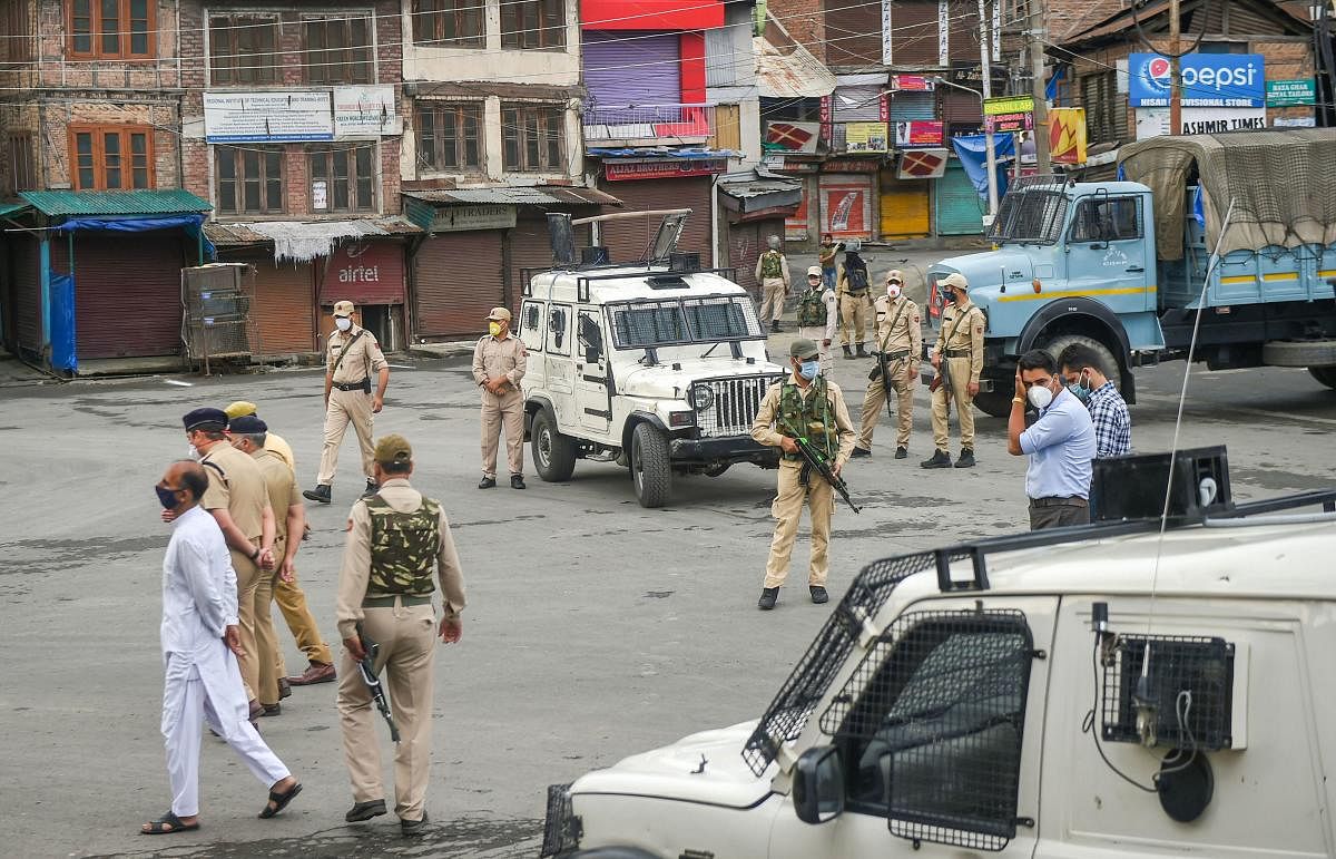 Srinagar: Security personnel stand guard on a street as seen on Eid al-Adha during the lockdown to contain the spread of coronavirus, in Srinagar, Saturday, Aug 1, 2020. The authorities have appealed to the people to offer prayers in their homes and not t