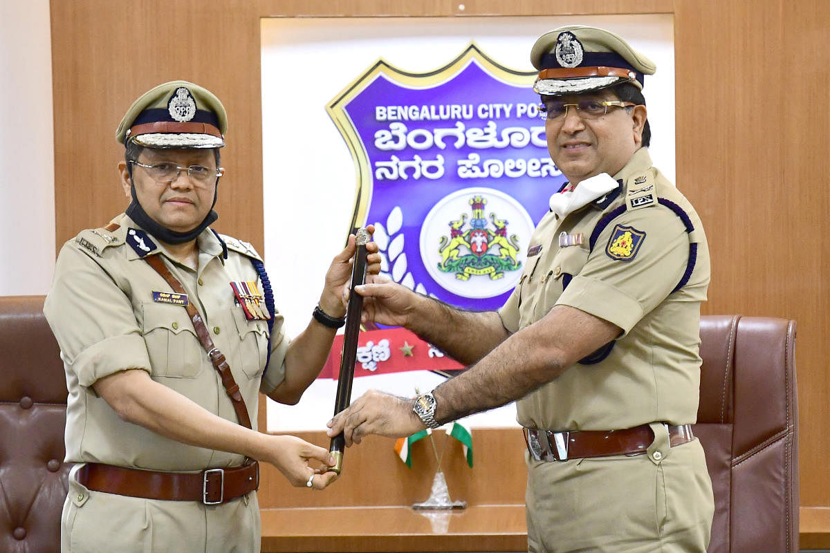 Bengaluru city new Police Commissioner Kamal Pant (left) taking charge from Bhaskar Rao (right) at Police Commissioner office in Bengaluru on Saturday, 01 August 2020. Photo by S K Dinesh