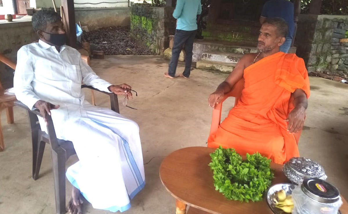 Minister for Muzrai, Religious Endowment and Fisheries Kota Srinivas Poojary interacts with Pejawar seer Vishwaprasanna Theertha Swami, at Neelavara Gaushala near Brahmavar.