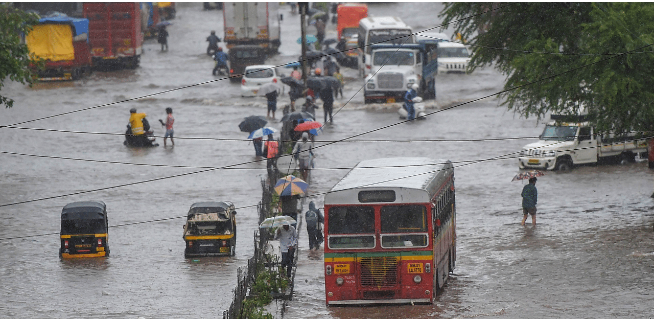 Vehicles ply on a waterlogged street at Kurla during monsoon rains in Mumbai. Credits: PTI Photo